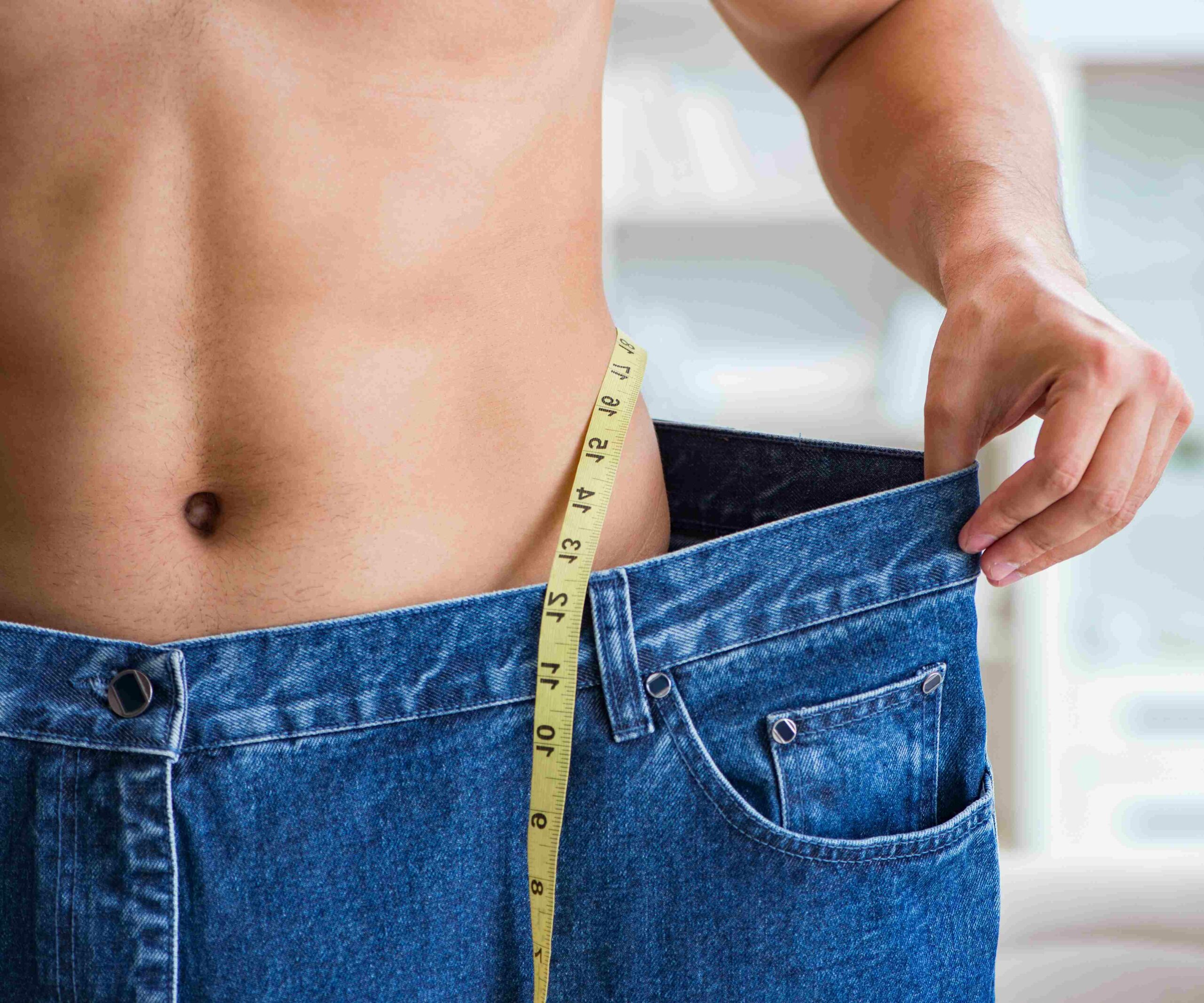 Men Showing His Loose Geans After Medical Weight Loss Treatment | Mirror Mirror Aesthetics and Wellness in Tucson, AZ