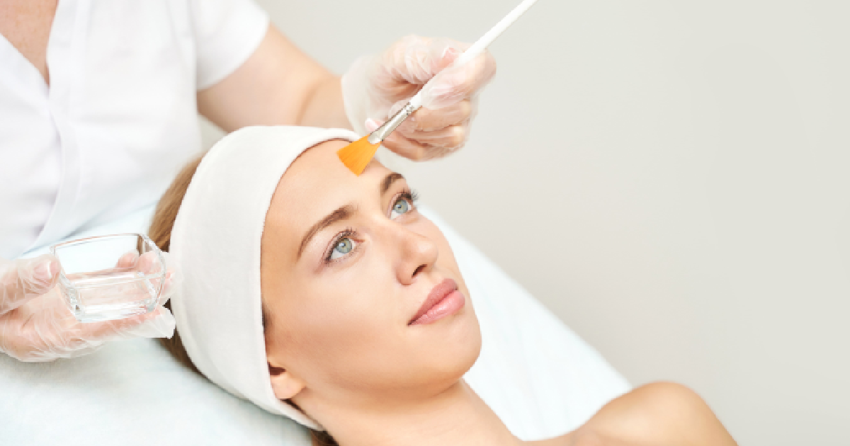 A person is receiving a chemical peel treatment in Tucson, AZ with a brush and small bowl of liquid.